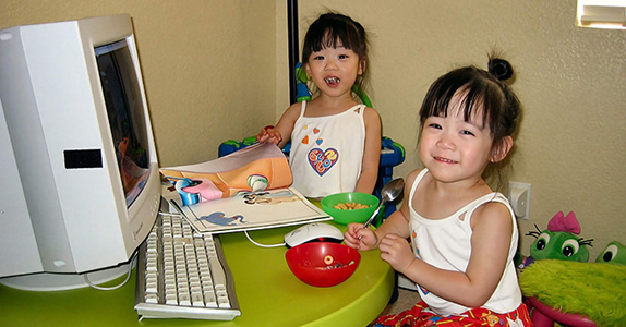 baby madi and audrey with computer